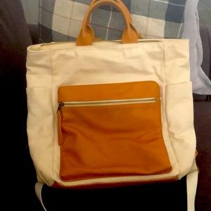 Universal thread faux leather and canvas backpack.